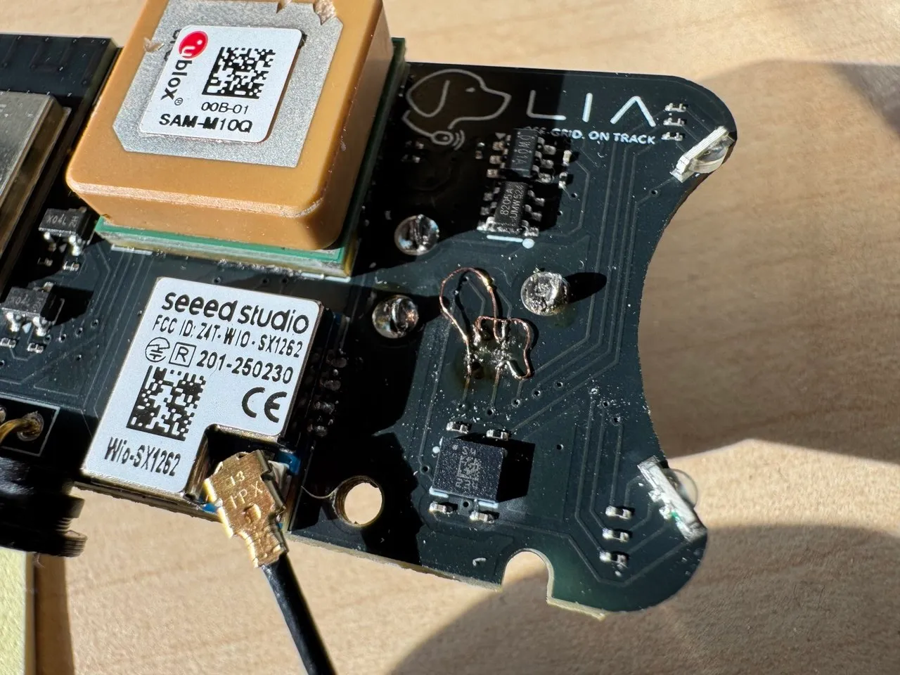 Two crossed jumper wires soldered in place of the cut routes