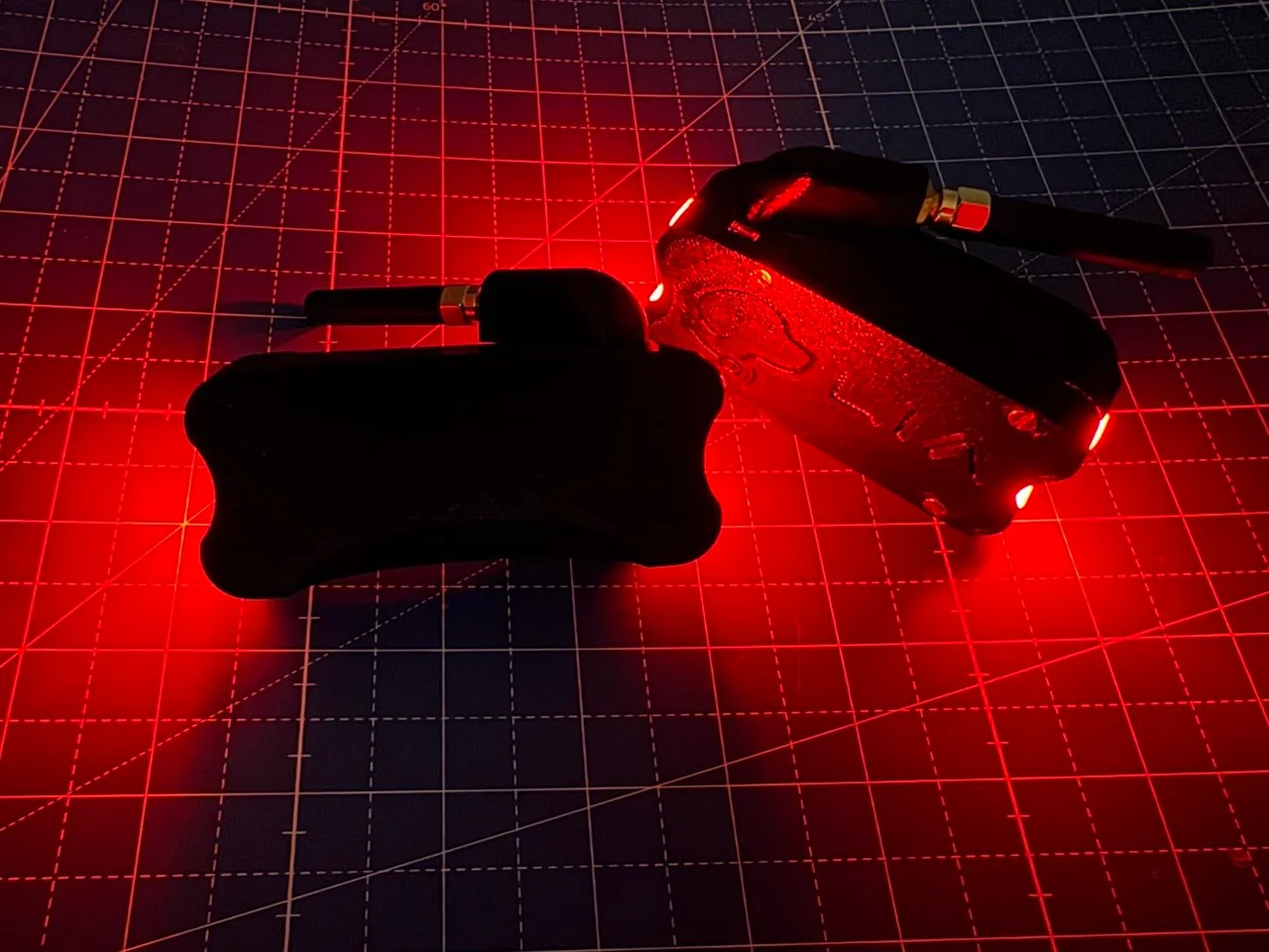 Two closed enclosures glowing red in the dark
