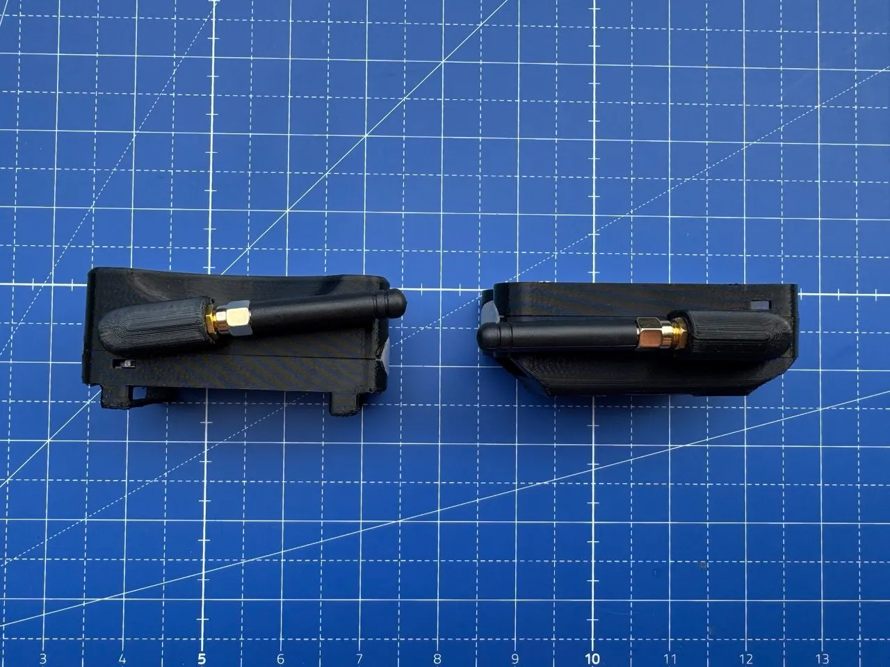 Two enclosure prototypes compared side by side, antenna end