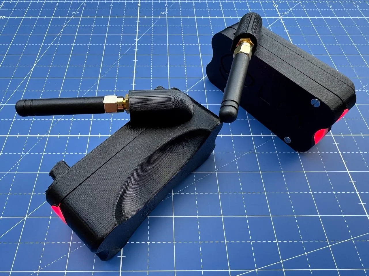 Two enclosure prototypes at an angle, comparing antenna mounting