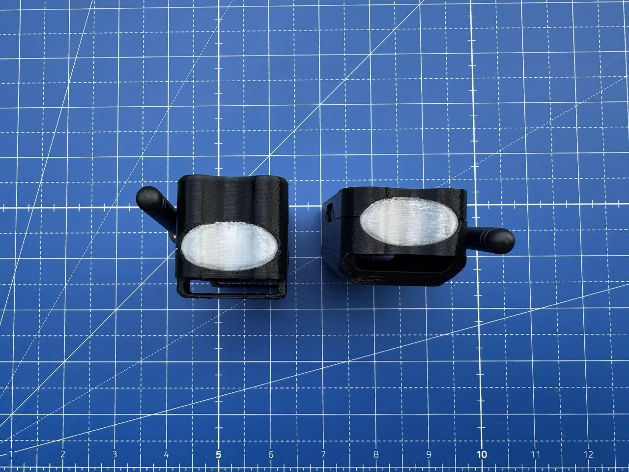 Two enclosures viewed from the antenna end, the oval LED window unlit