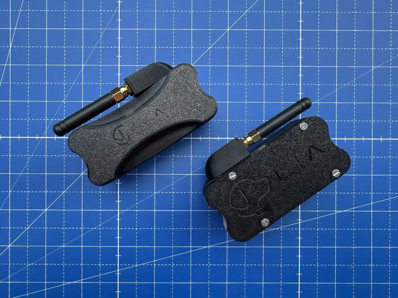 Two enclosures viewed from above, comparing antenna mount styles